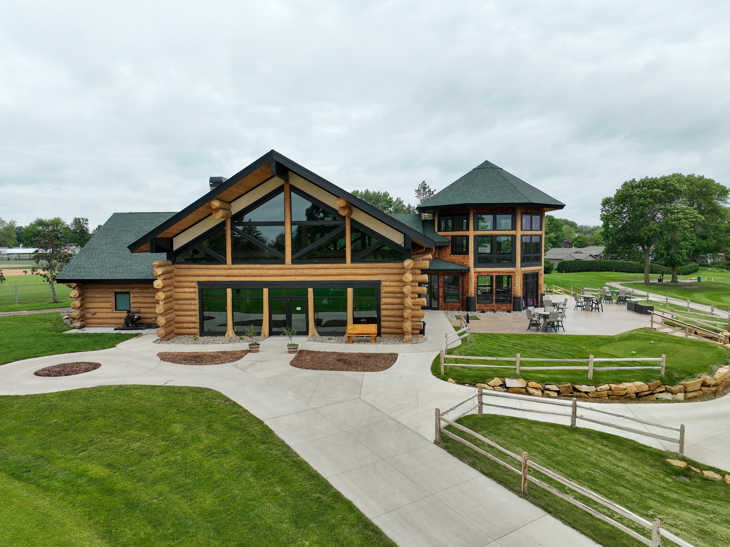 Drone view of the log cabin clubhouse and patio at Montgomery National Golf Club in Montgomery, Minnesota