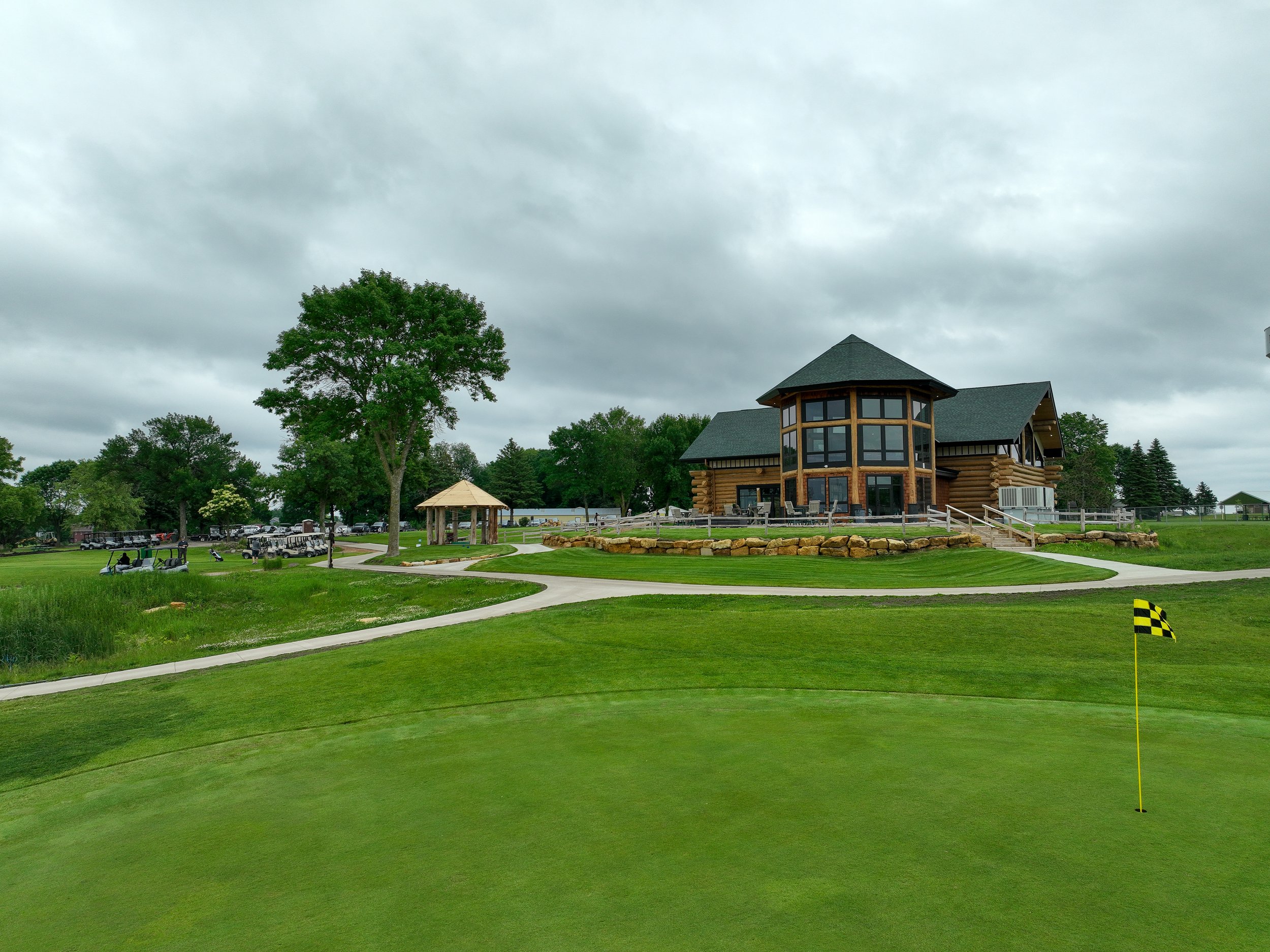 The log cabin clubhouse seen from across a green at Montgomery National Golf Club