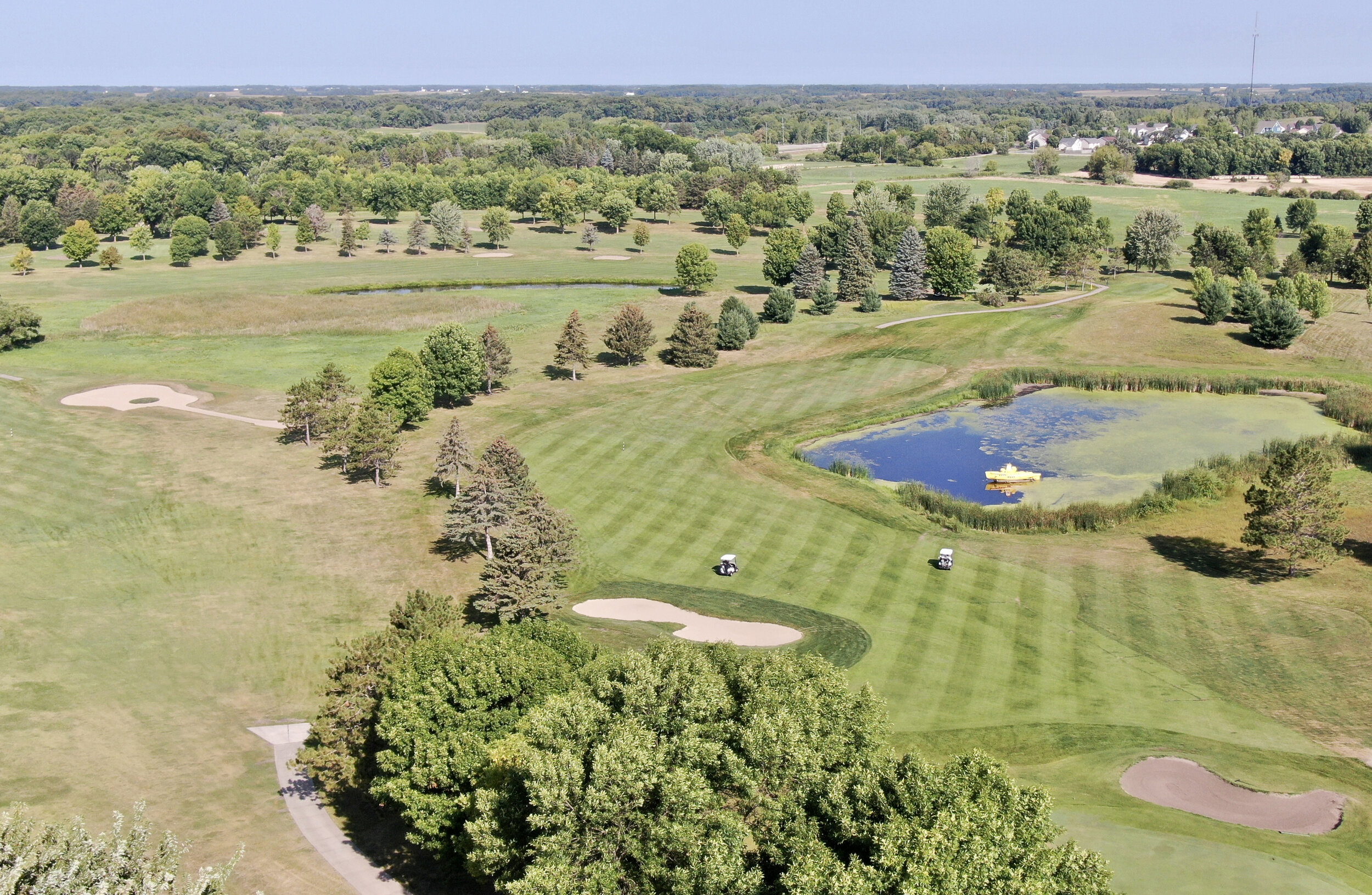 Aerial view of the 18th hole at Montgomery National, with the yellow submarine in the pond and bunkers along the fairway